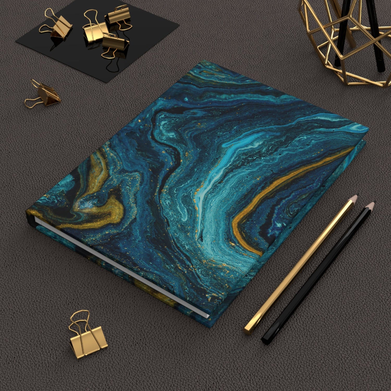 Artistic hardcover journal with blue and gold marbled cover, perfect for writing and sketching