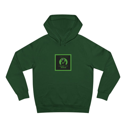 Unisex premium green hoodie with "an EYE for design a HEART for JESUS" faith-inspired graphic and kangaroo pocket